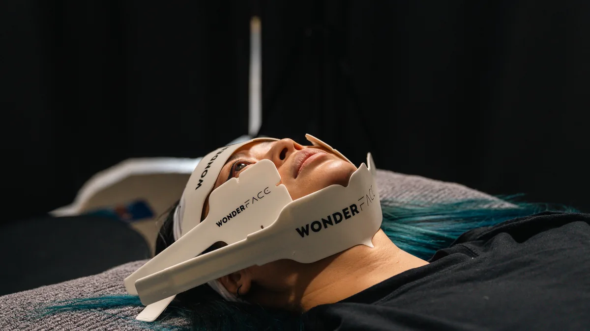 WonderFace EMS and radiofrequency electrodes wrapping the under-chin and jawline area during a treatment session at Kaizen Therapy in Bentleigh, Melbourne